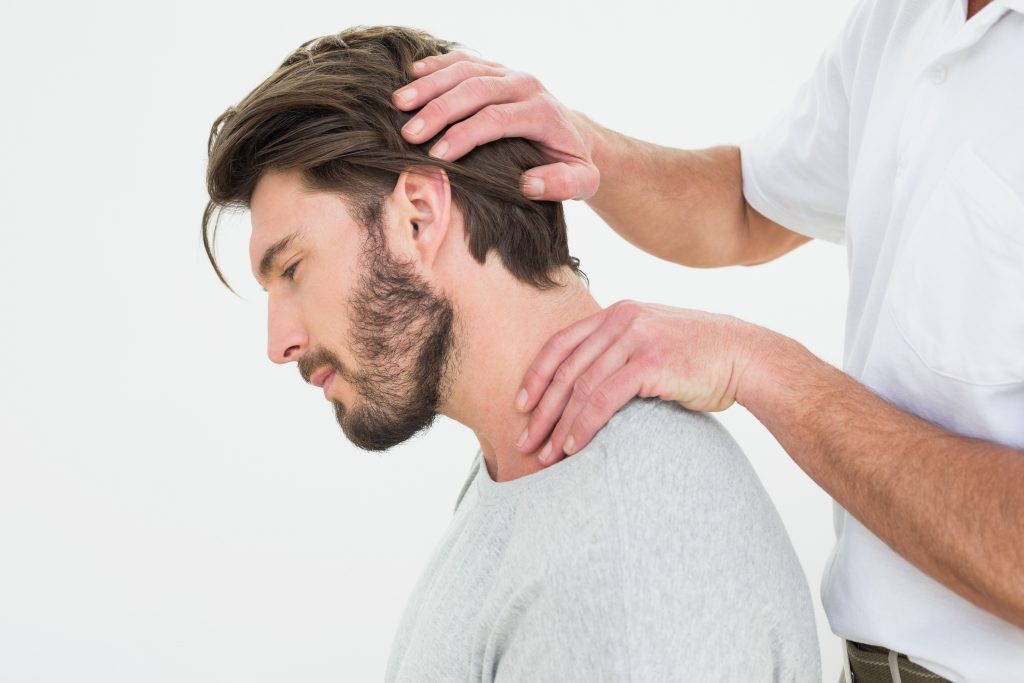 Doctor examining patient with neck pain, Chiropractor Pinellas Park can provide health treatment for your ailment.